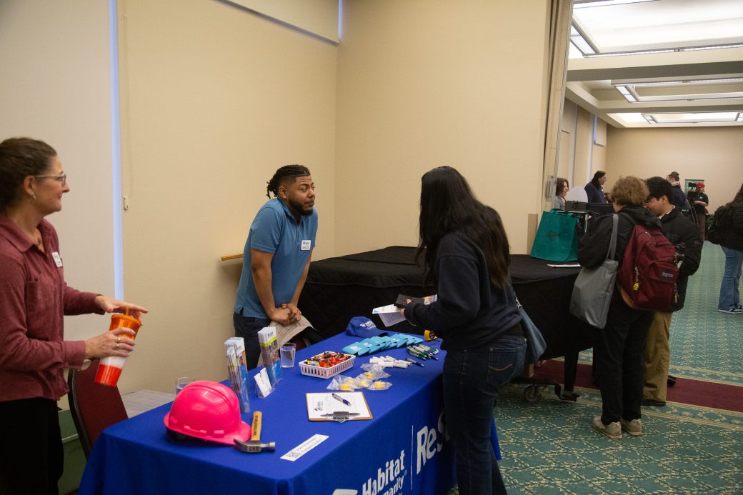 A man and a woman talking at Community Engagement Fair