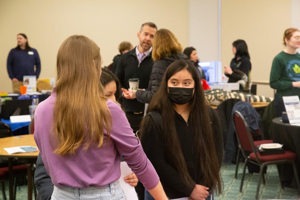 Two women talking Community Engagement Fair