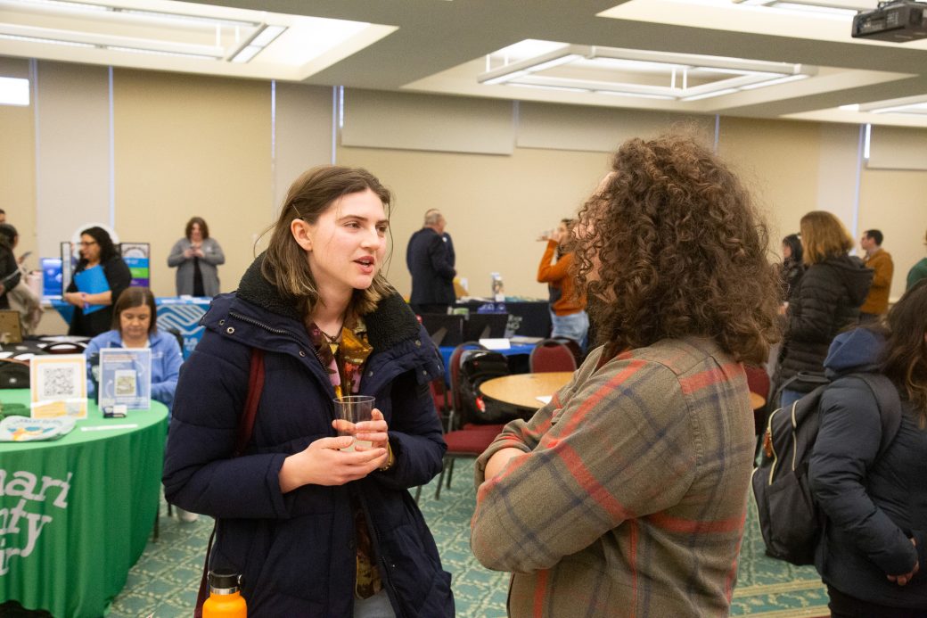 Two women talking at Community Engagement Fair