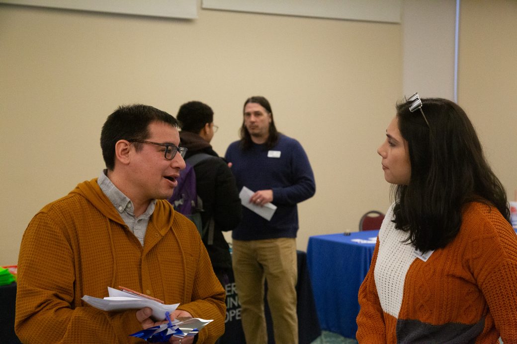 A woman and a man talking at Community Engagement Fair