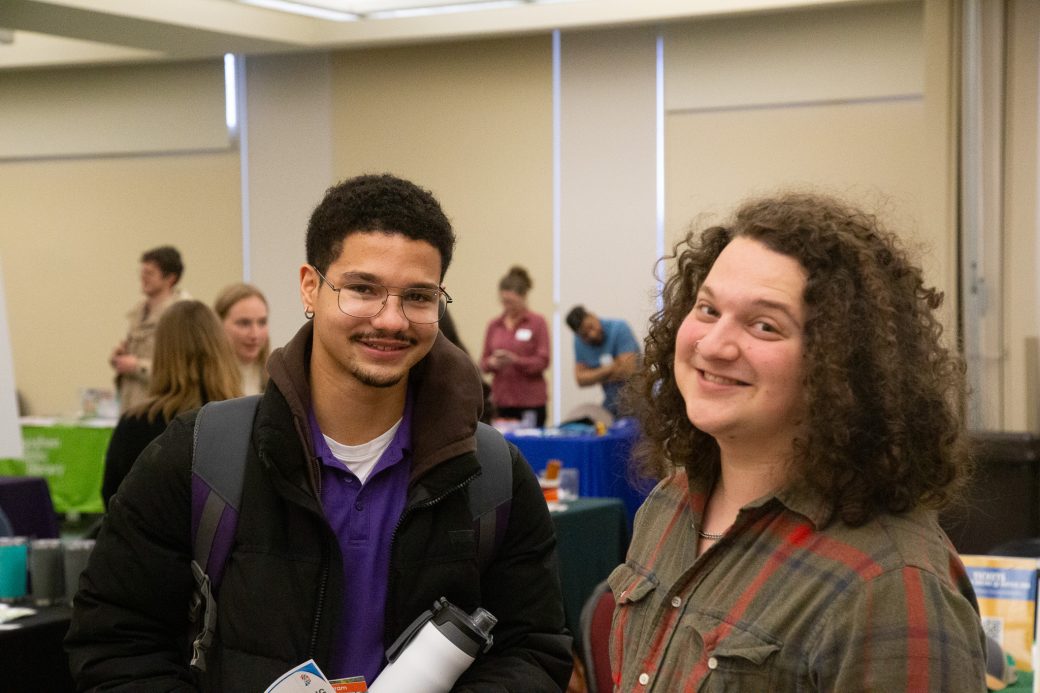 A man and a woman smiling to the camera