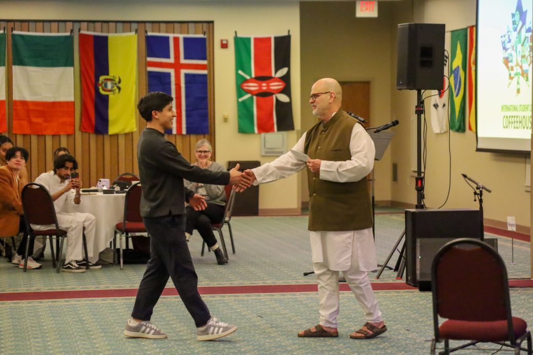 Goshen College student receiving a award for his academic performance