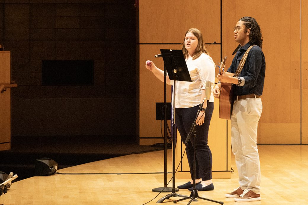 a man playing guitar and a women singing