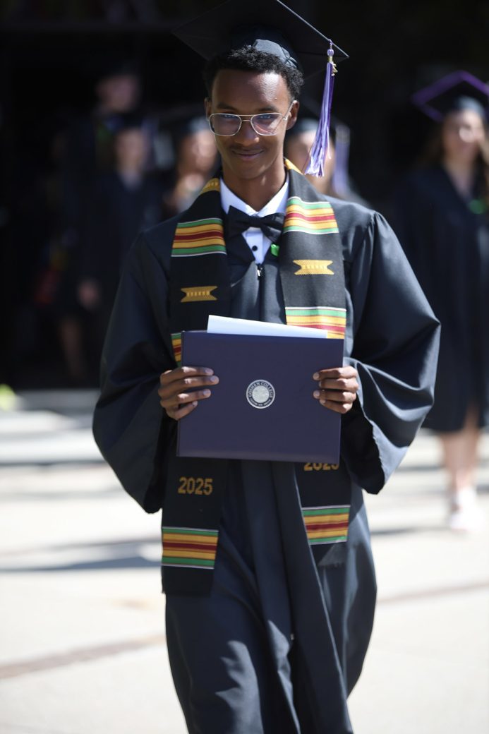 students walking with his diploma
