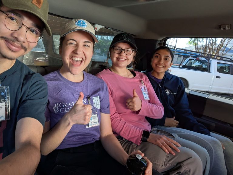 selfie of students in a car with their thumbs up