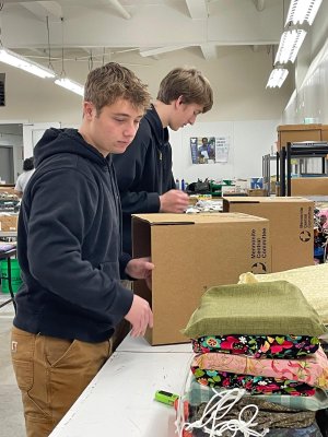 students working with cardboard boxes