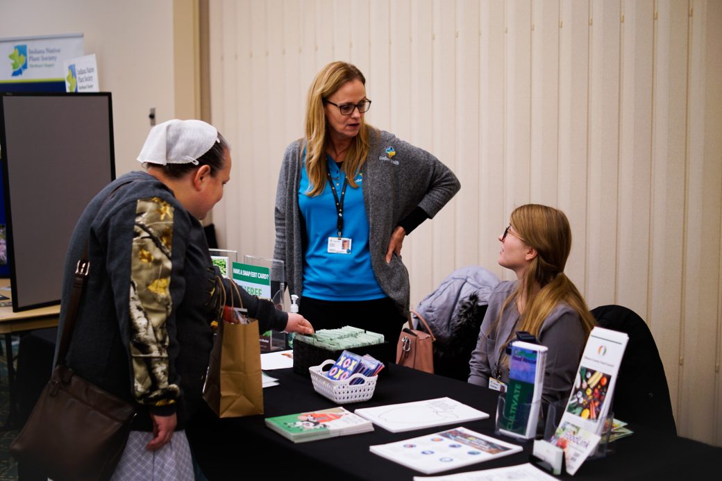 People talking in a table at Michiana Regional Seed Swap