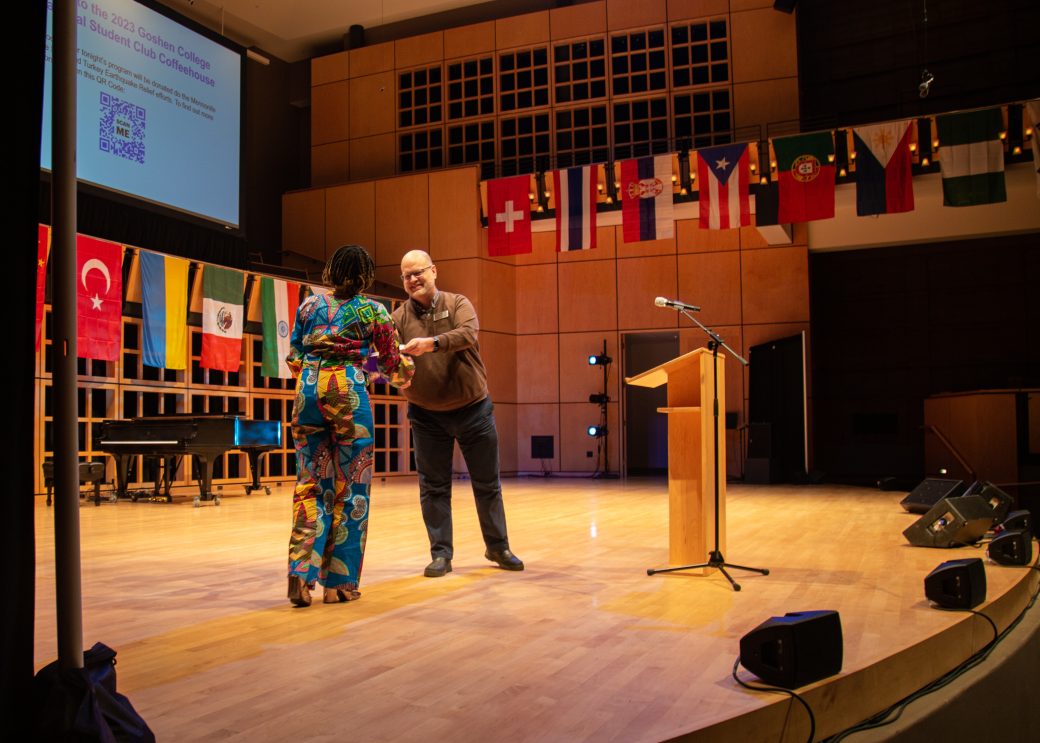 A man and a woman handshaking at International Student Club Coffeehouse 2023