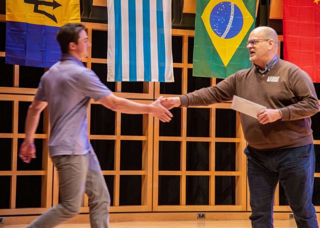 Two men handshaking at International Student Club Coffeehouse 2023