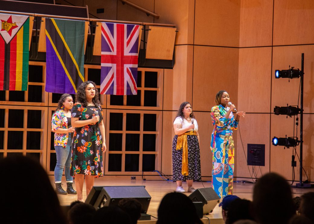Women singing on the stage at International Student Club Coffeehouse 2023