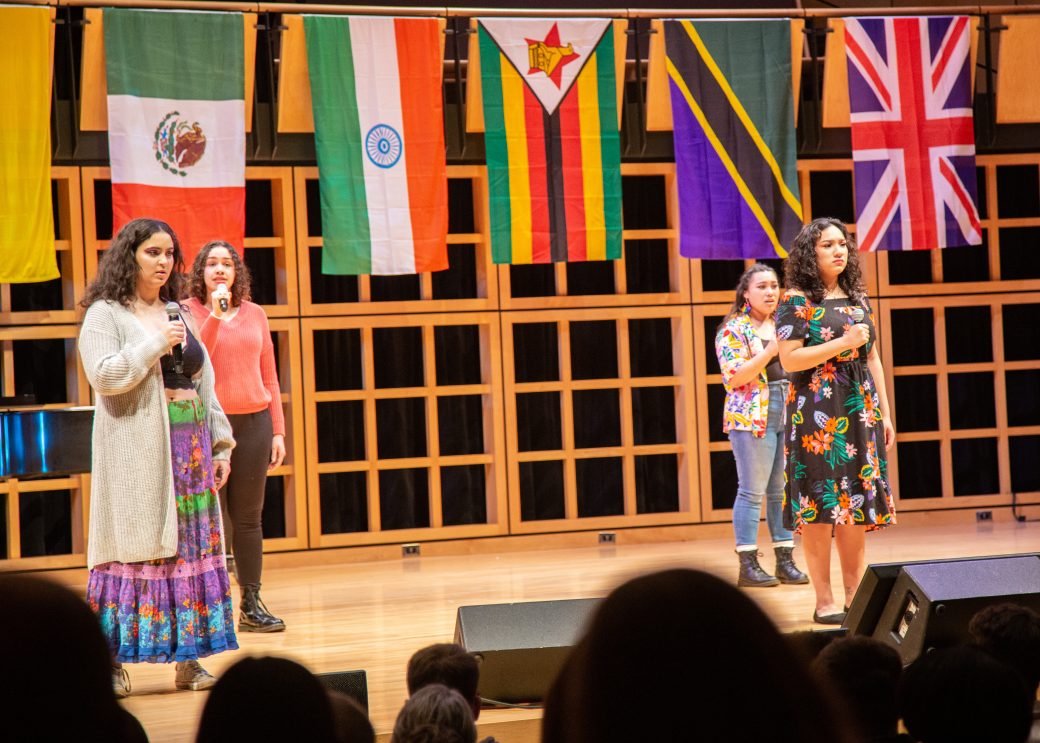 Women singing on the stage at International Student Club Coffeehouse 2023