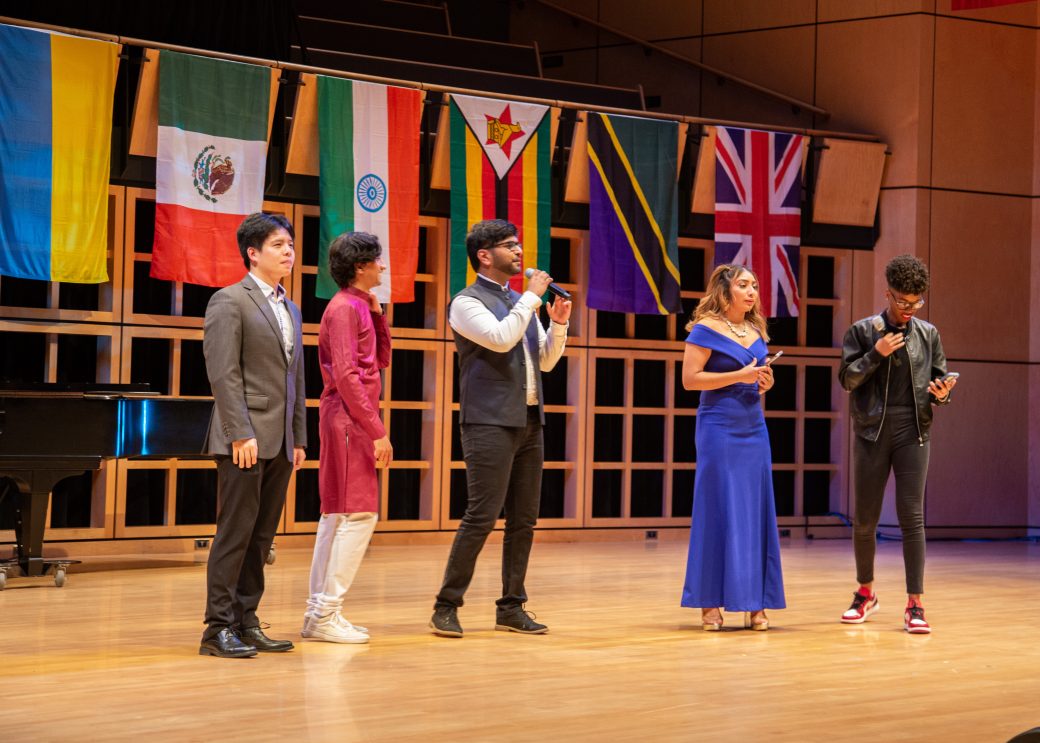 People singing on the stage at International Student Club Coffeehouse 2023