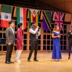 People singing on the stage at International Student Club Coffeehouse 2023
