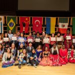 People smiling to the camera at International Student Club Coffeehouse 2023