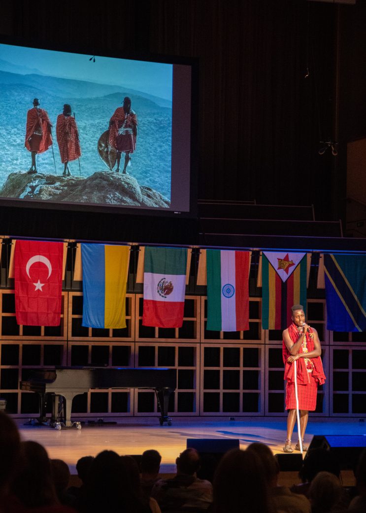 Woman speaking in a stage at International Student Club Coffeehouse 2023