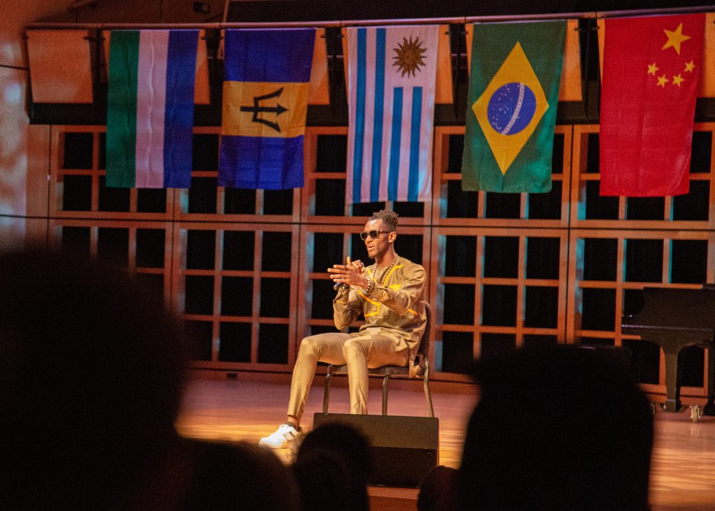 A man doing an artistic performance on the stage at International Student Club Coffeehouse 2023