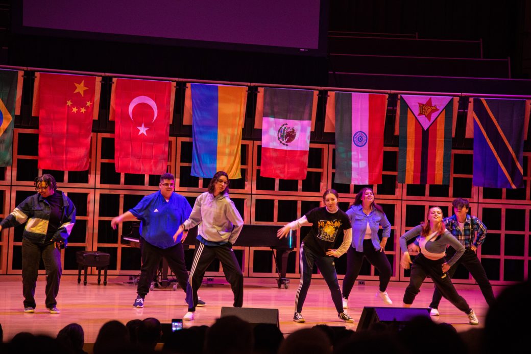 People dancing on the stage at International Student Club Coffeehouse 2023
