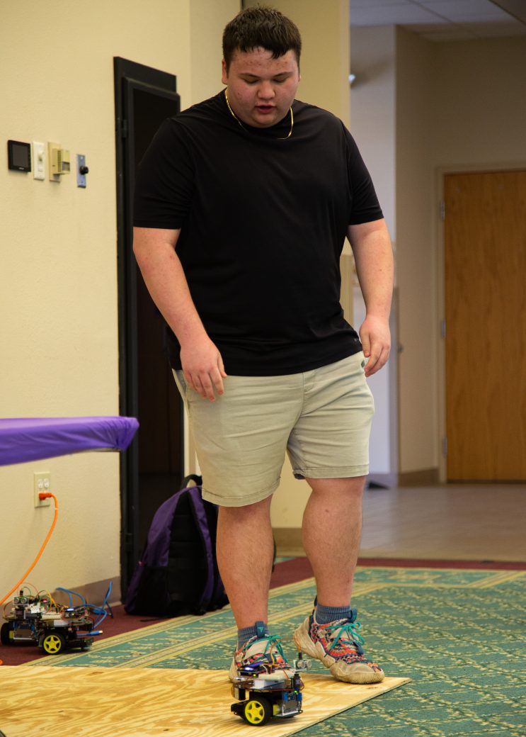 Man playing with a eletronic toy with two wheels