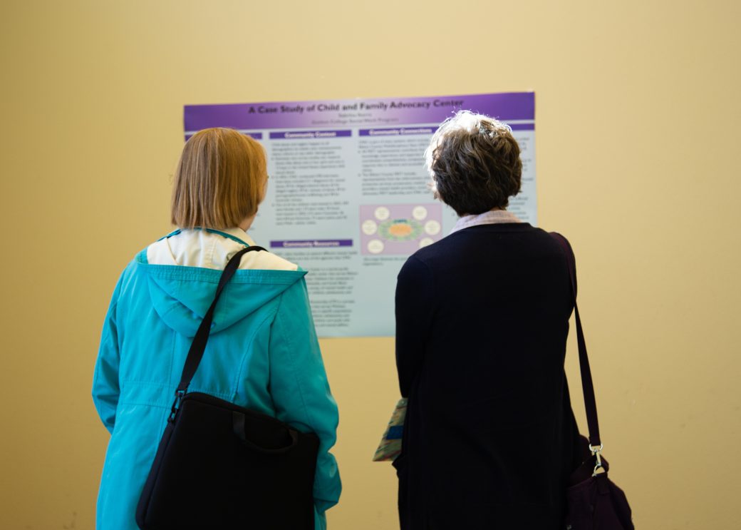 Two women looking a plate at Academic Symposium 2023