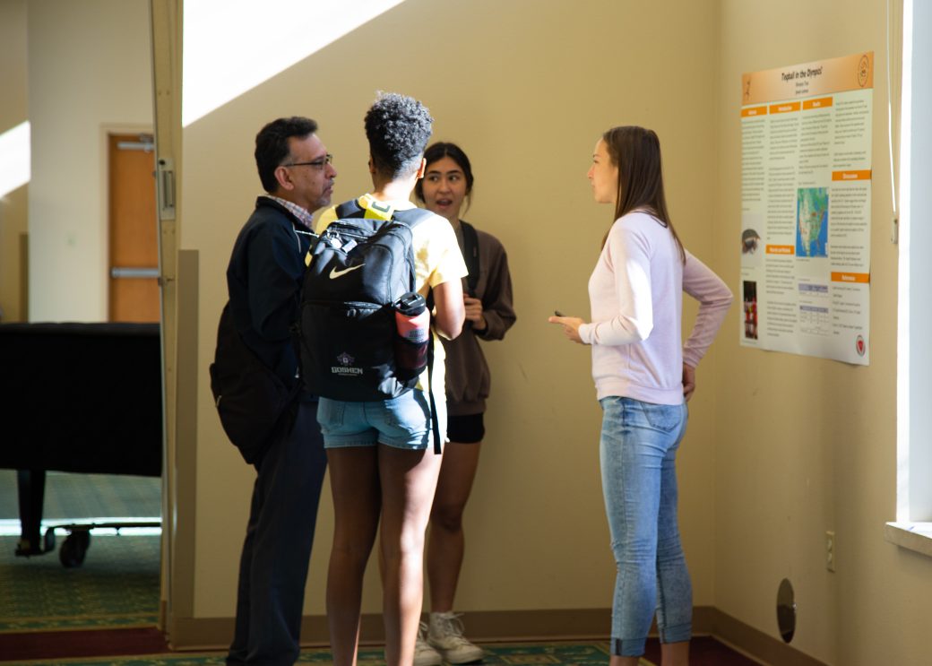 People talking at Academic Symposium 2023