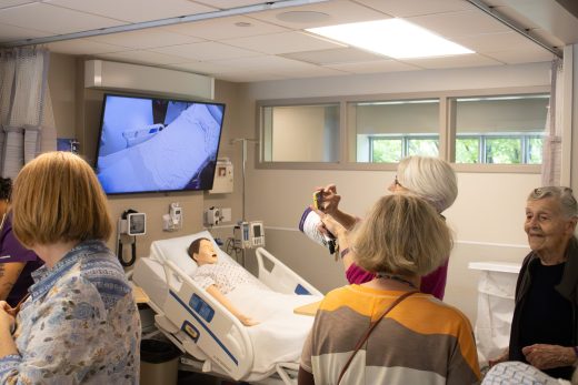 Two visitors exploring the new nursing simulation rooms