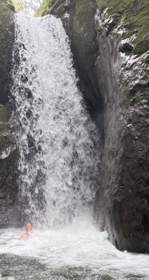 Enjoying the excitement of a waterfall in Mindo.