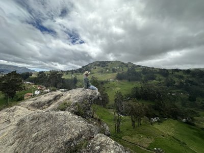 A picturesque example of me doing just that: sitting on the ledge of a rock and gazing out at the sprawling Cañar Province below me.