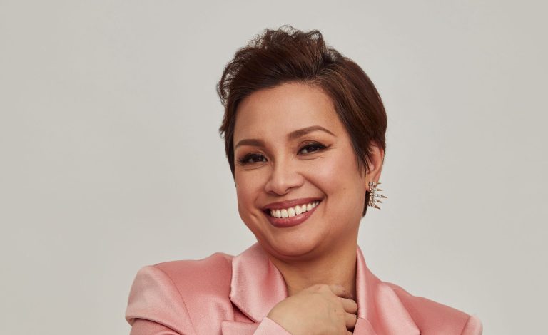 A headshot of a smiling Lea Salonga in a salmon blazer