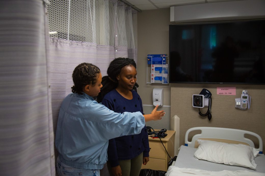 Students perform mock exams in a hospital room