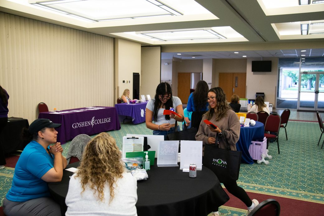 Two women talking with the women of the table