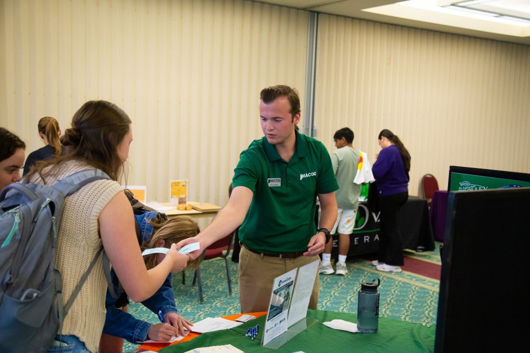 A man giving a paper about health to a woman