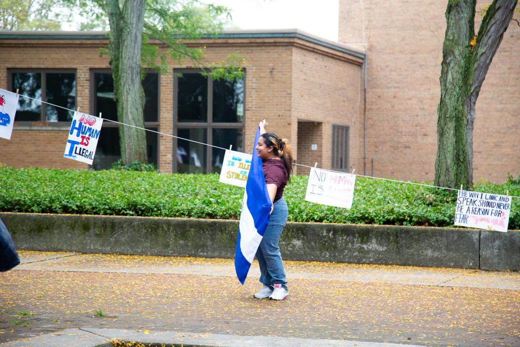 A woman with Honduras flag at Hispanic Heritage Month Convocation and Celebration