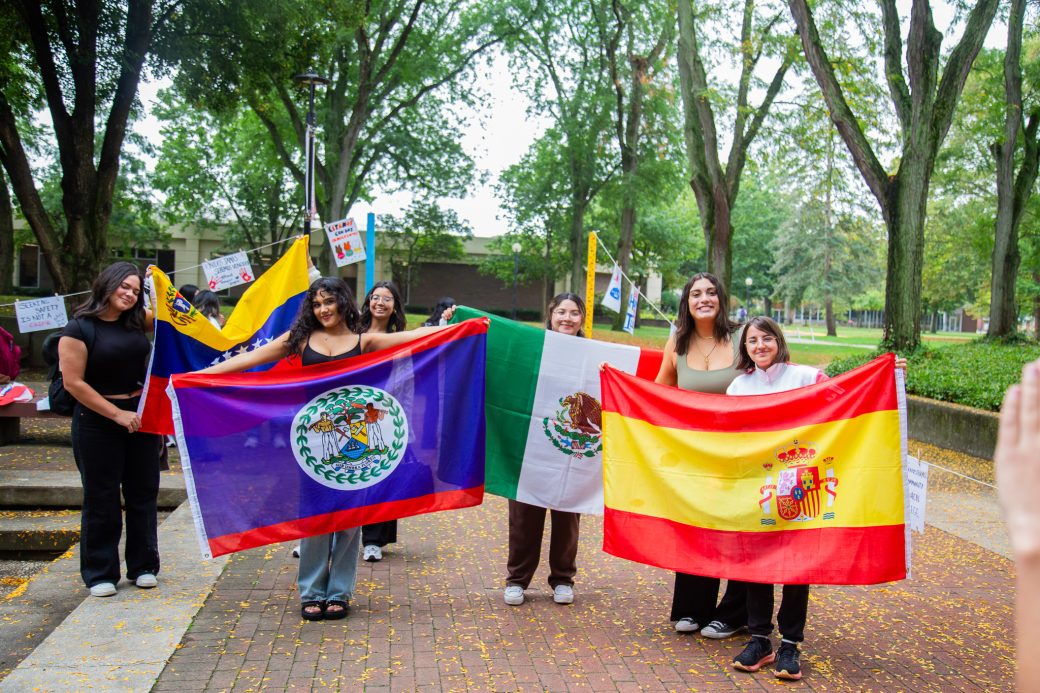 People with their countrie's flags at Hispanic Heritage Month Convocation and Celebration