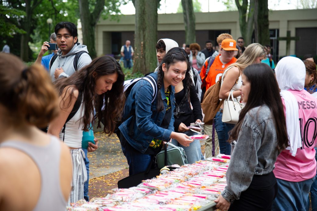 A woman buying something at Hispanic Heritage Month Convocation and CelebrationHispanic Heritage Month Convocation and Celebration
