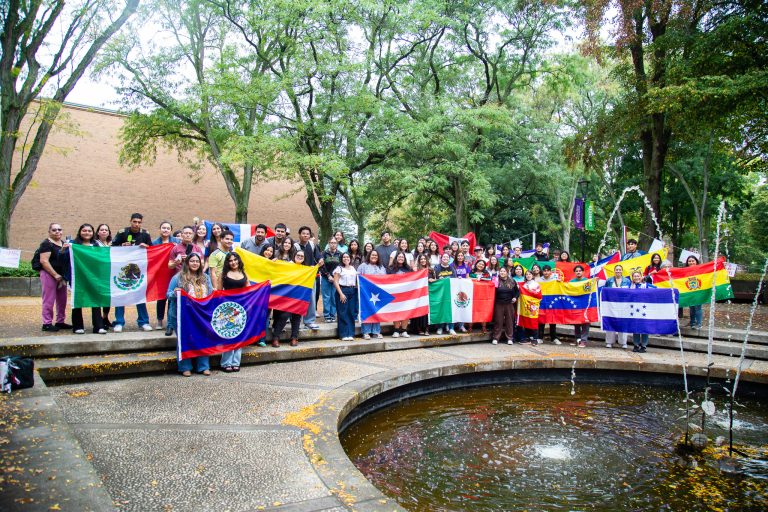 People with their countries' flags at Hispanic Heritage Month Convocation and Celebration