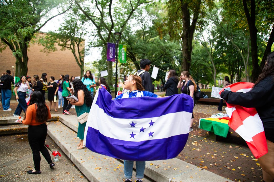 A woman with Honduras flag at Hispanic Heritage Month Convocation and Celebration