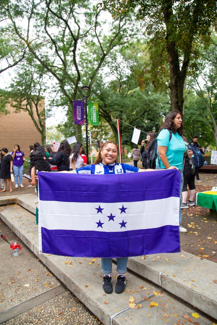A woman with Honduras flag at Hispanic Heritage Month Convocation and Celebration