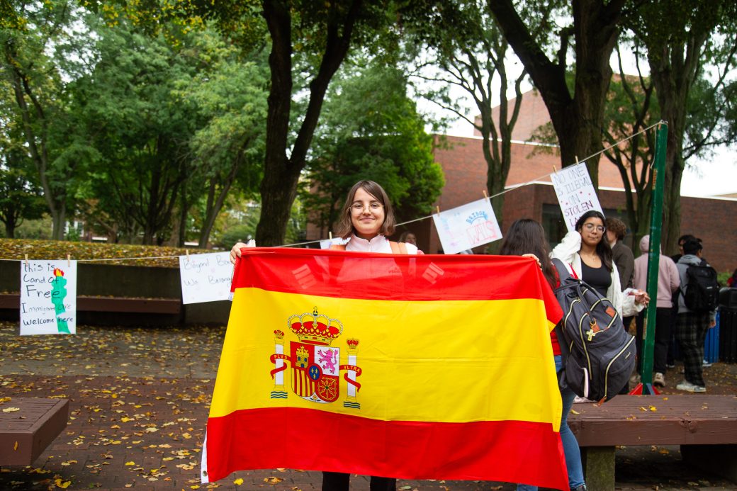 A woman with Spain's flag at Convocation and Celebration