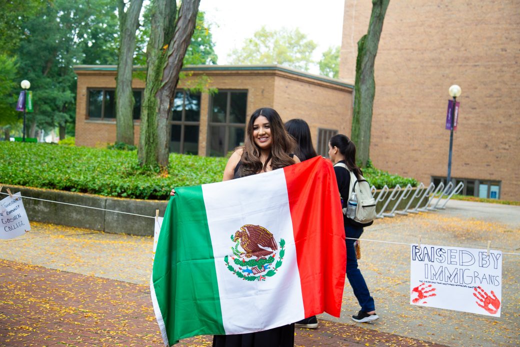 A woman with Mexico's flag at Convocation and Celebration