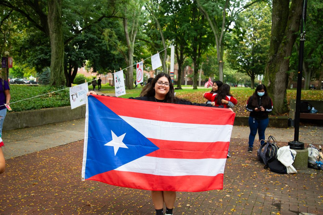 Woman with Puerto Rico's flag at Hispanic Heritage Month Convocation and Celebration