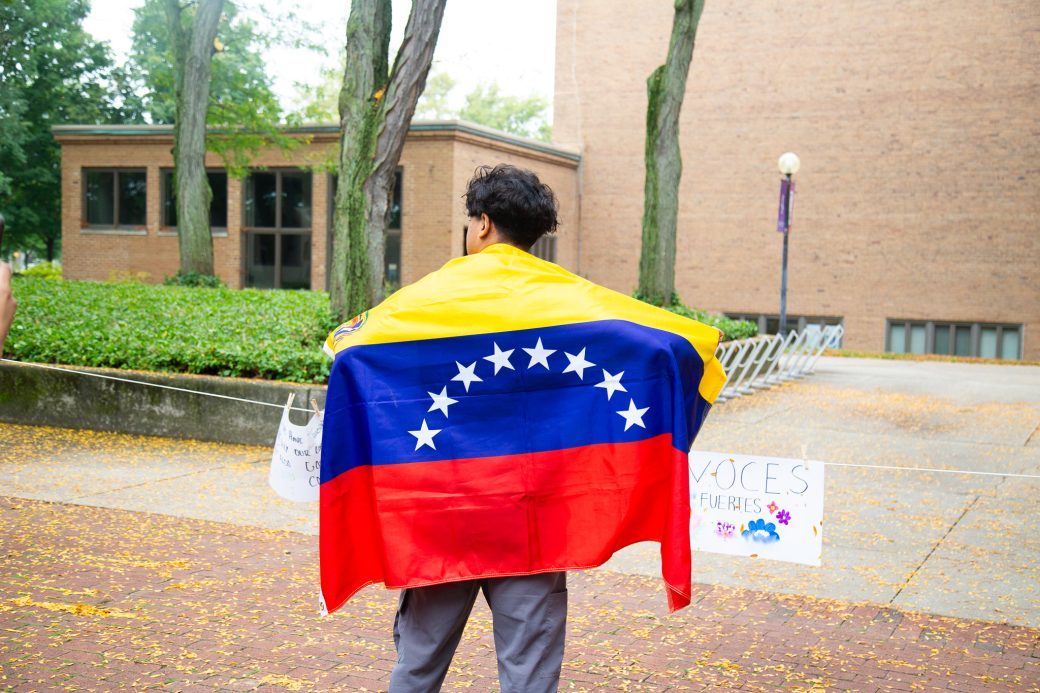 A man with Venezuela's flag at Convocation and Celebration