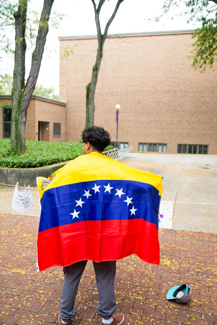 A man with Venezuela's flag at Convocation and Celebration