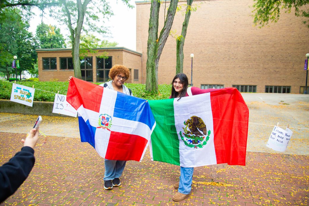 people with their countries' flags at Hispanic Heritage Month Convocation and Celebration