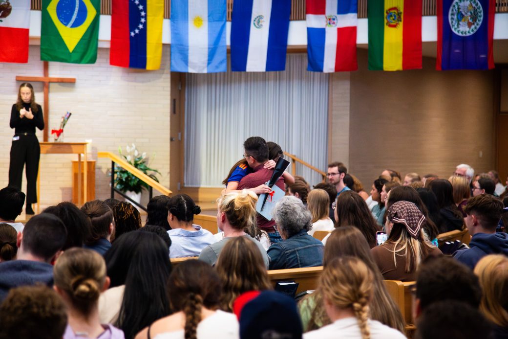A women and a men hugging at Hispanic Heritage Month Convocation and Celebration