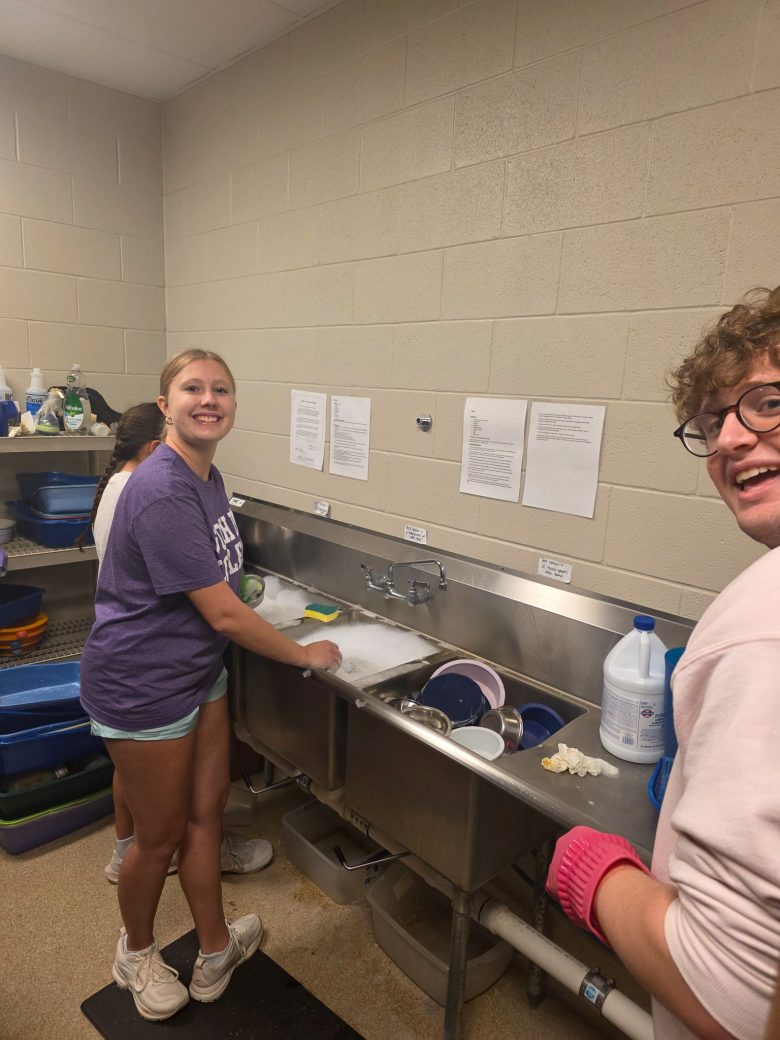 A man and a woman washing dishes