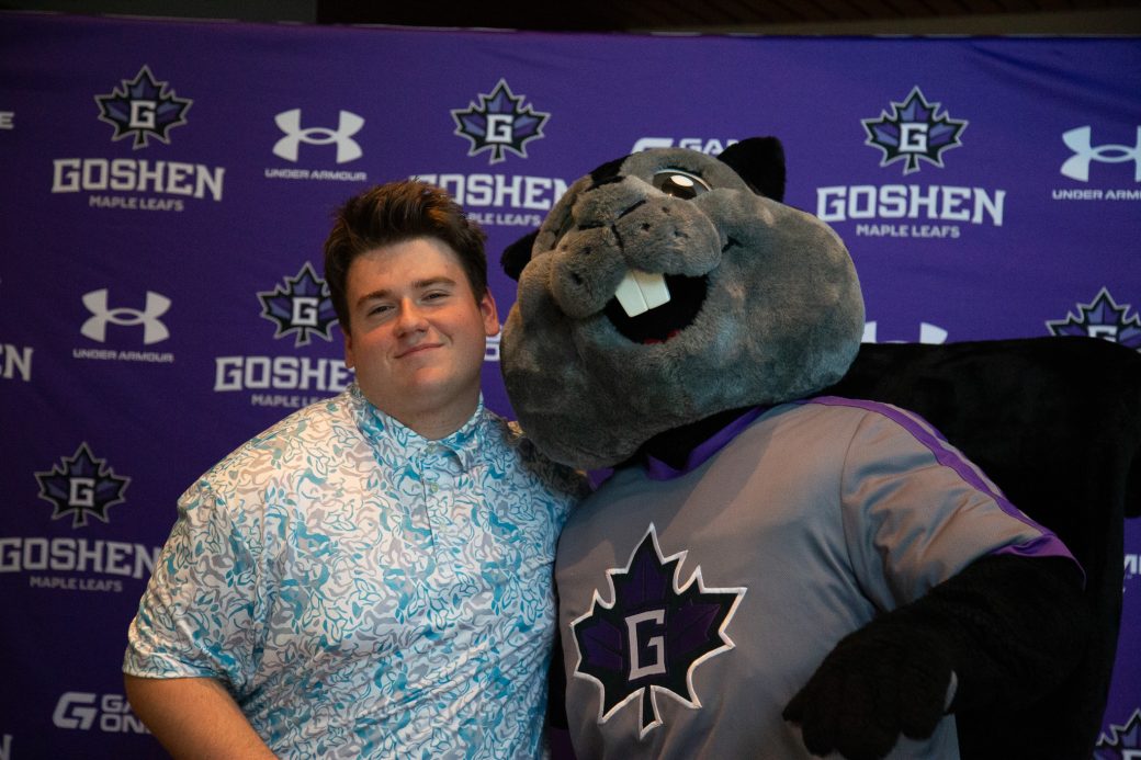 Dash posing with male student in light blue pattern shirt poses with