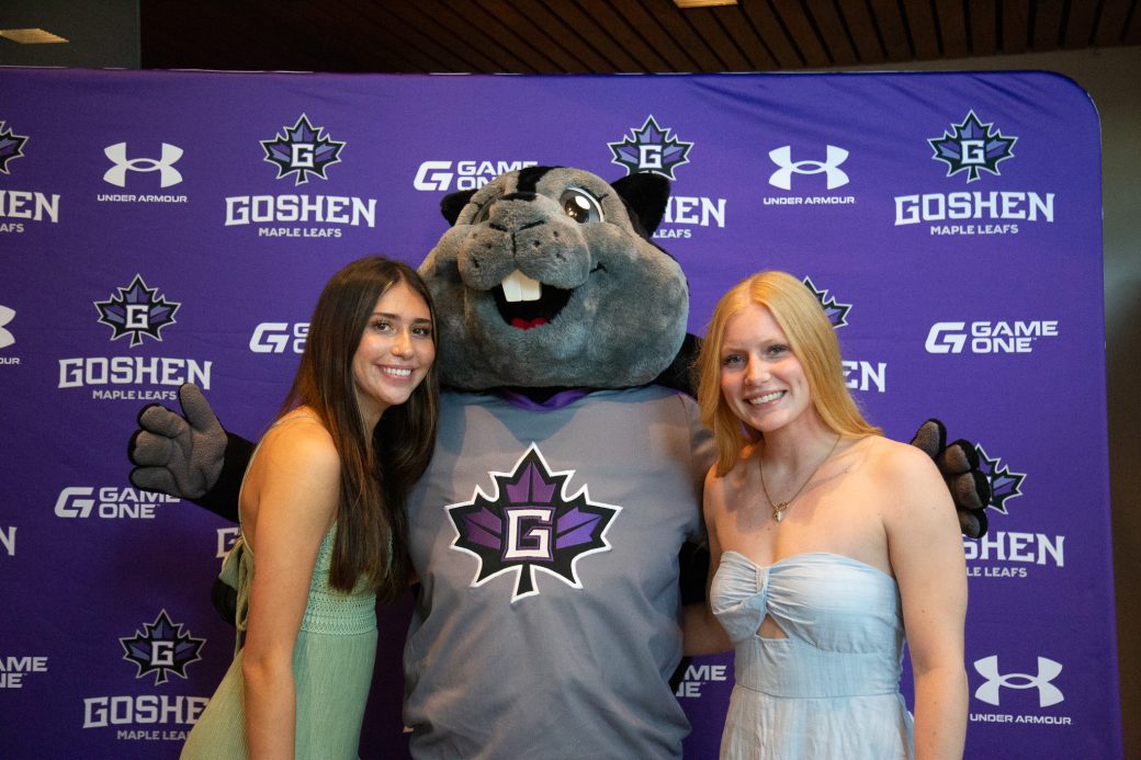 Dash poses with two female students