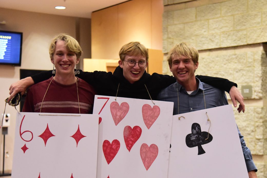 three men dressed as playing cards