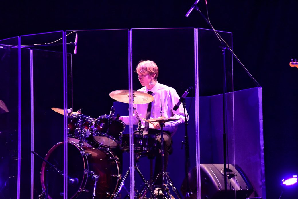 Man playing drums at Goshen's college stage