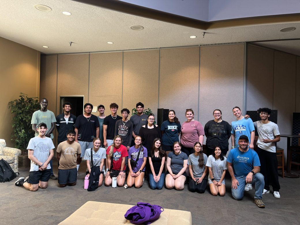 People smiling to the camera at Goshen College